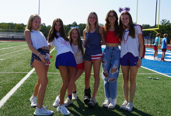 Cross Country runners smile for a photo on the football field for the dress up day 