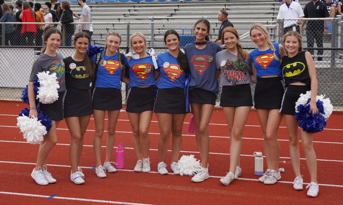 All the Cheerleaders Posing in their Super-Hero shirts for a picture