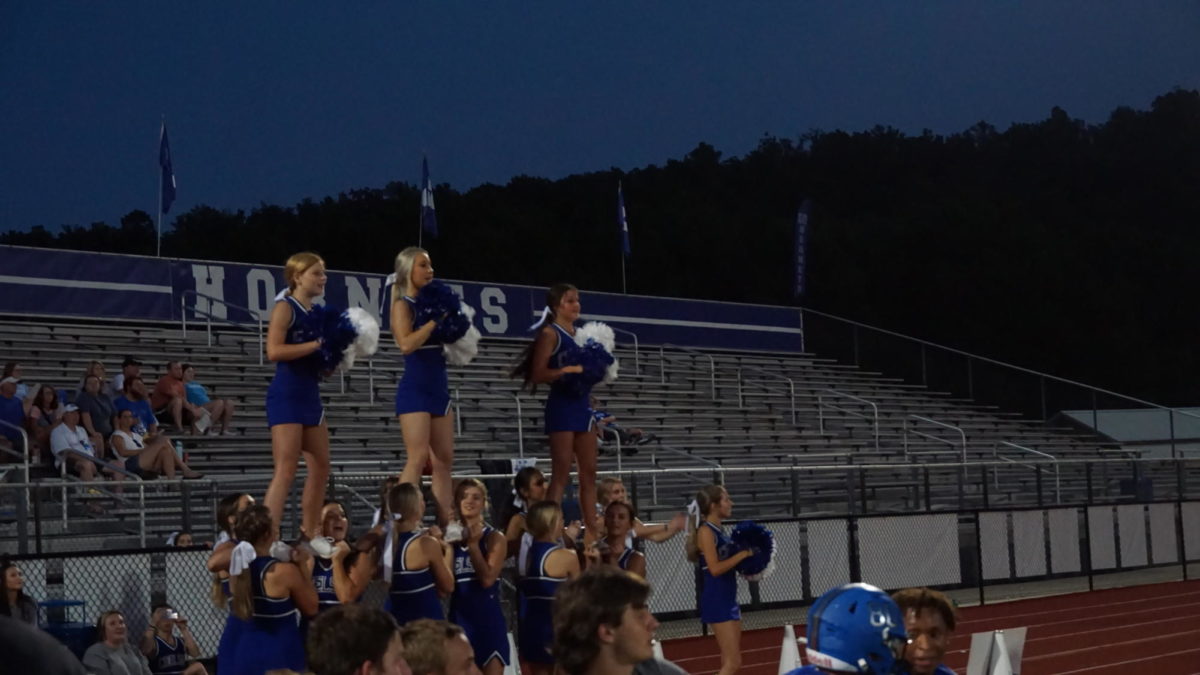 (Left to Right) The cheerleaders lift flyers Riley Racisborski, Kaitlyn Perry, and Lydia Anne Ruttka during a performance to cheer on the players.